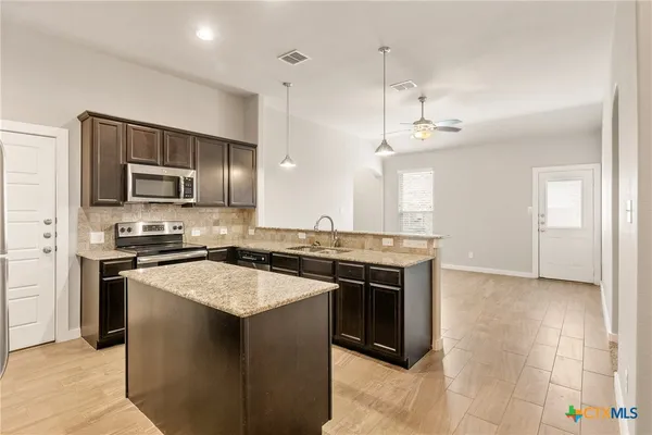 a kitchen with a stove and a microwave