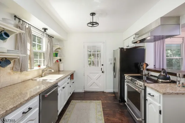 a kitchen with a sink stove and refrigerator