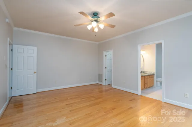 a view of an empty room with window and cabinet
