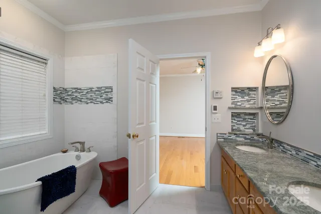 a spacious bathroom with a granite countertop tub sink and mirror