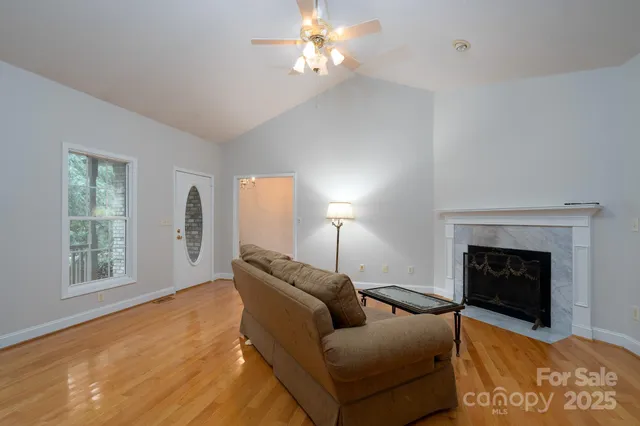 a living room with furniture a window and a fireplace