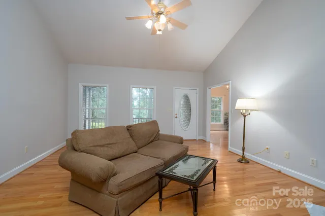a living room with furniture and a chandelier