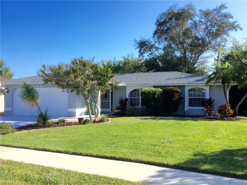 124 Versailles Circle Naples, FL 34112 - Photo 1 of 19 a front view of house with yard and green space