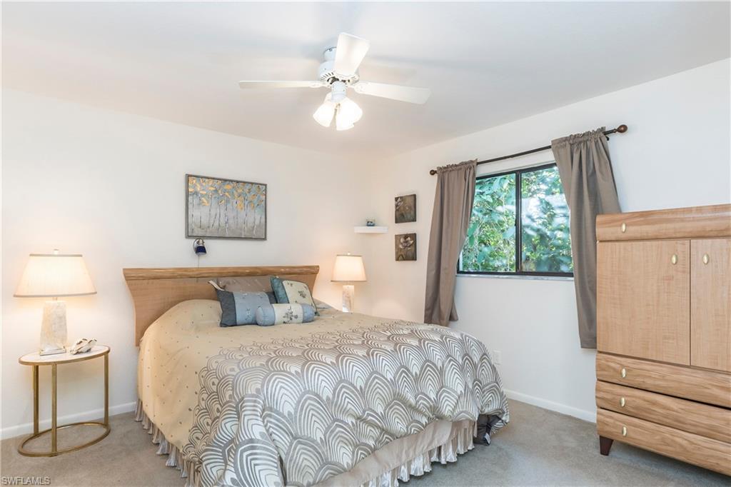 124 Versailles Circle Naples, FL 34112 - Photo 12 of 19 a bedroom with a bed and a window