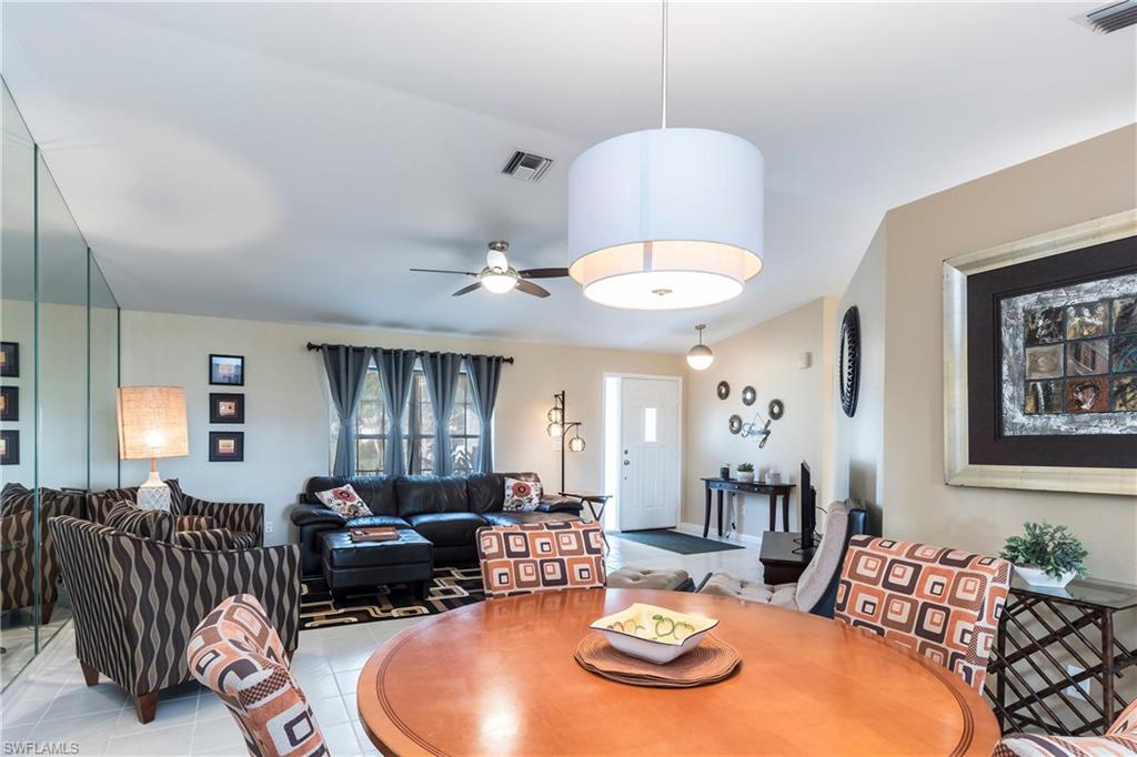 124 Versailles Circle Naples, FL 34112 - Photo 4 of 19 a living room with furniture kitchen view and a chandelier