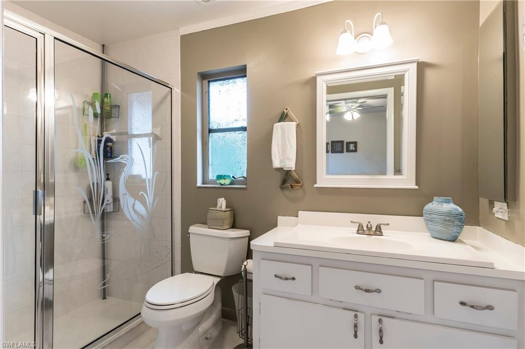 124 Versailles Circle Naples, FL 34112 - Photo 9 of 19 a bathroom with a sink toilet and shower