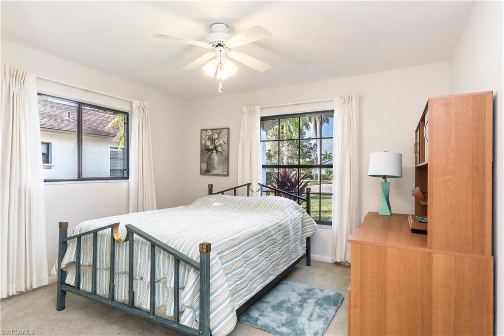 124 Versailles Circle Naples, FL 34112 - Photo 10 of 19 a bedroom with a bed table and a window