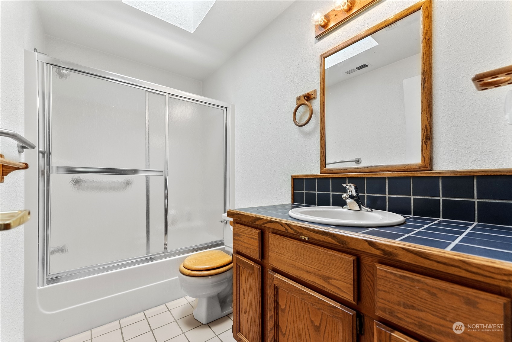 10 Pogue Road Okanogan, WA 98840 - Photo 26 of 40 a bathroom with a sink a toilet a mirror and shower