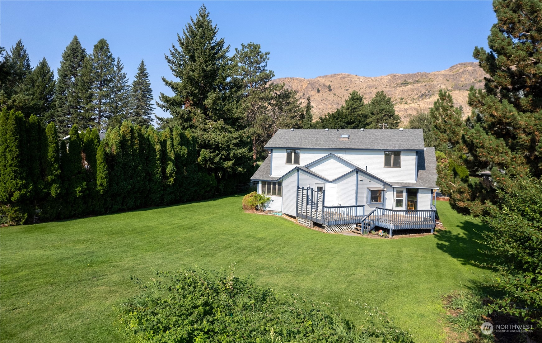 10 Pogue Road Okanogan, WA 98840 - Photo 4 of 40 a front view of a house with a yard and trees