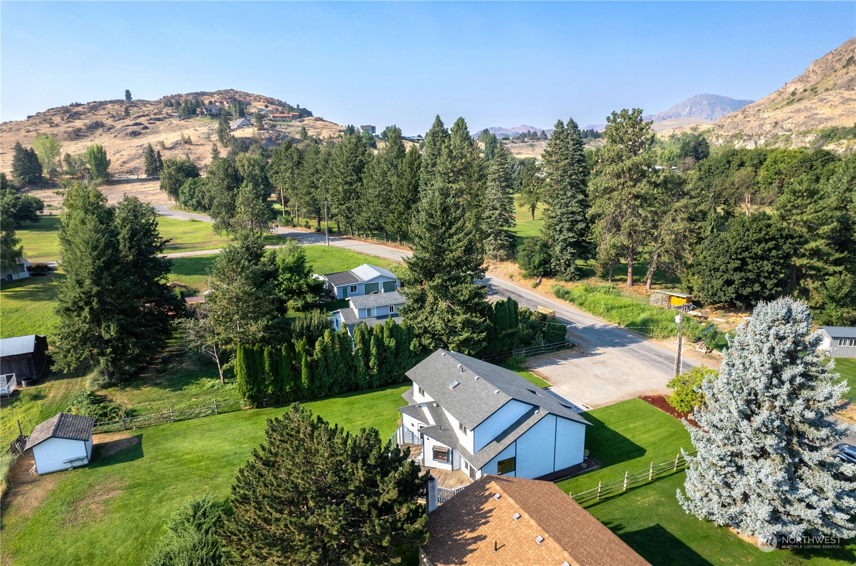 10 Pogue Road Okanogan, WA 98840 - Photo 6 of 40 a view of a garden with a building in the background