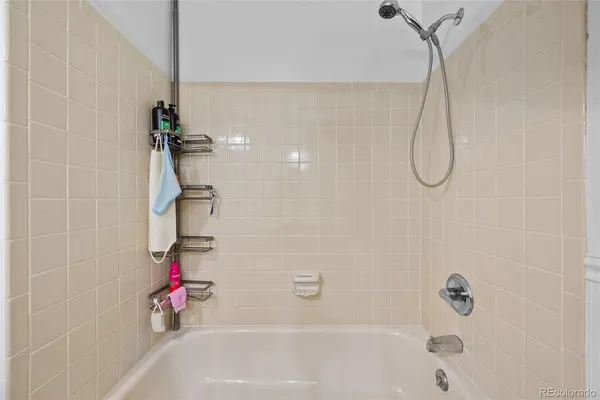 a bathroom with a bath tub with a shower
