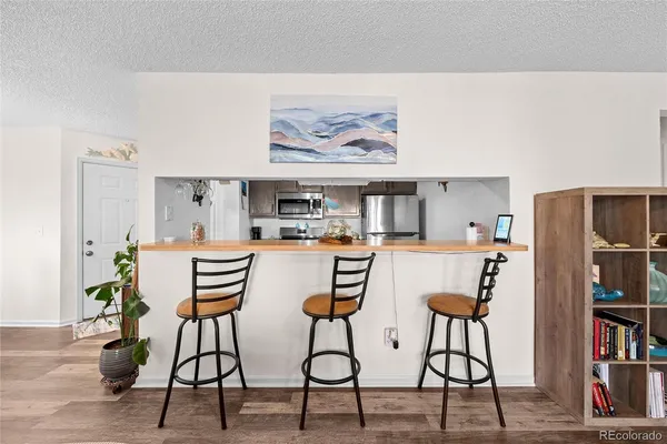 a dining room with furniture and wooden floor