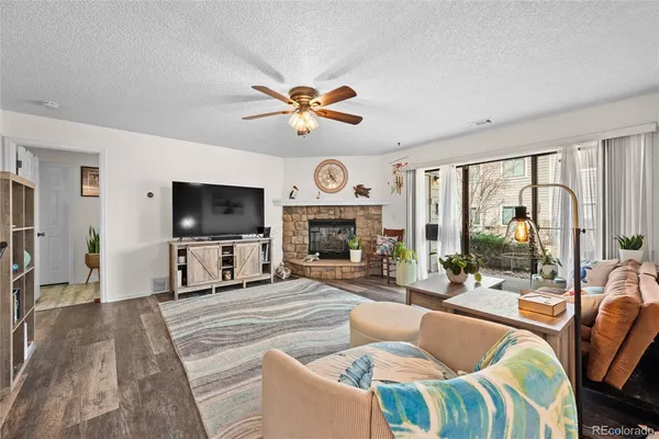 a living room with fireplace furniture and a flat screen tv