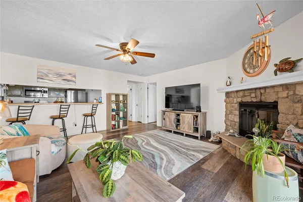a living room with furniture a flat screen tv and a fireplace