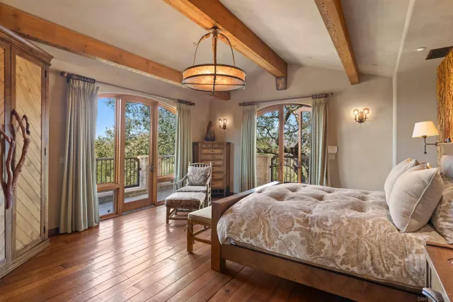 a bedroom with a bed and a chandelier
