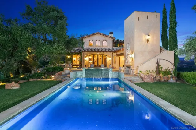 a backyard of a house with lots of green space and fountain
