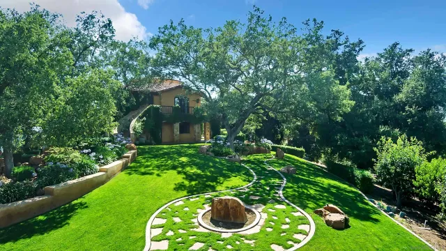 an aerial view of a house with a yard