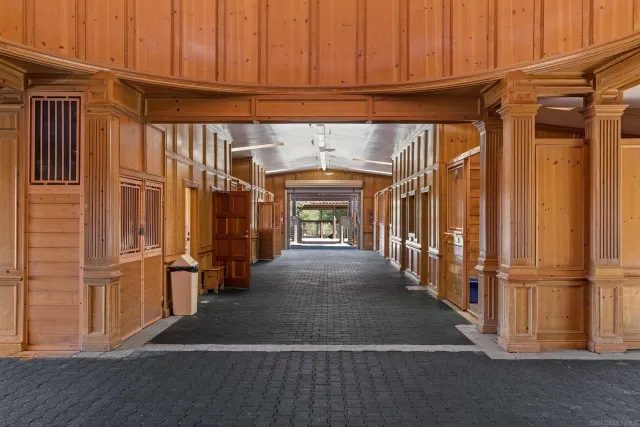 an aerial view of a house with pool and a yard