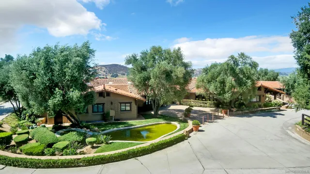 a view of a patio with furniture and garden
