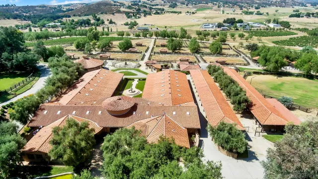 an aerial view of residential house with outdoor space and trees