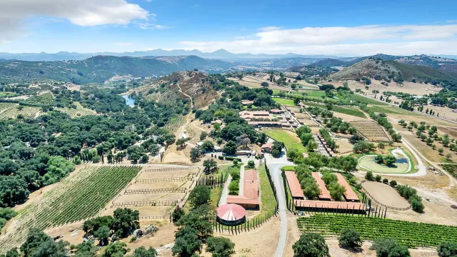 an aerial view of a house with a mountain