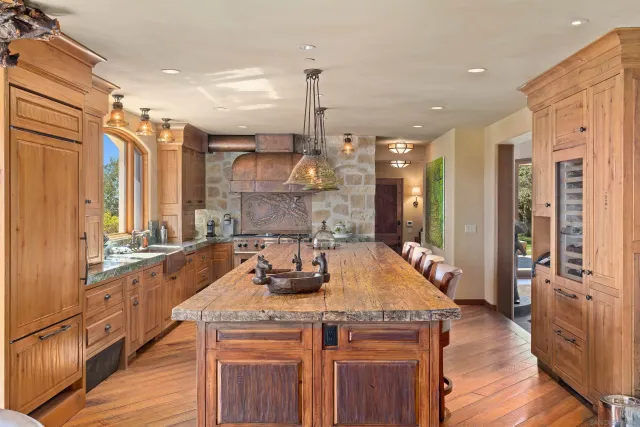a kitchen with a sink a stove and a wooden floor
