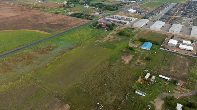 an aerial view of a residential houses with outdoor space