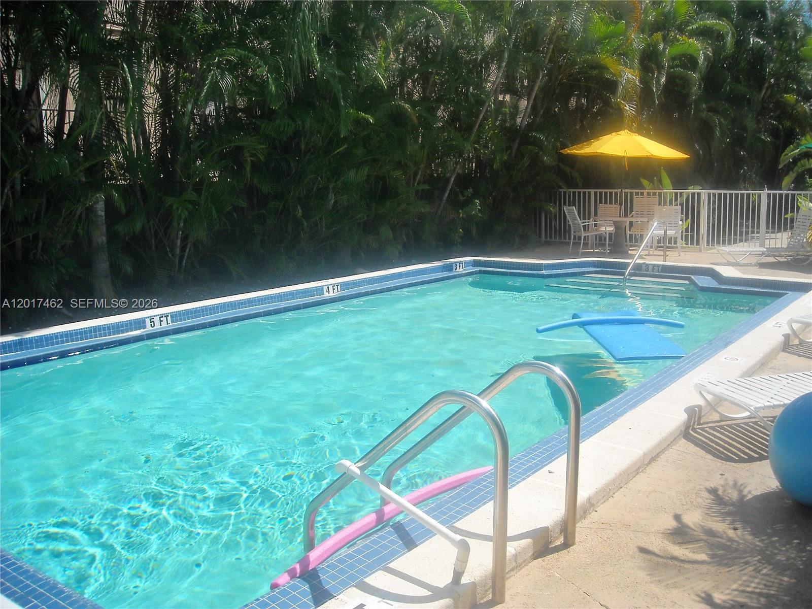 325 Fernwood Road, Unit 10 Key Biscayne, FL 33149 - Photo 2 of 12 a view of swimming pool