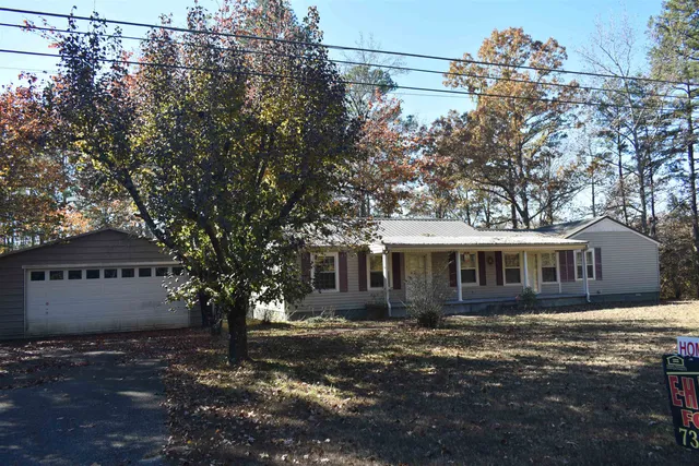 a view of a house with a tree in front