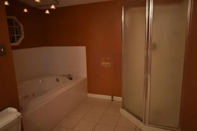 a bathroom with a tub and shower