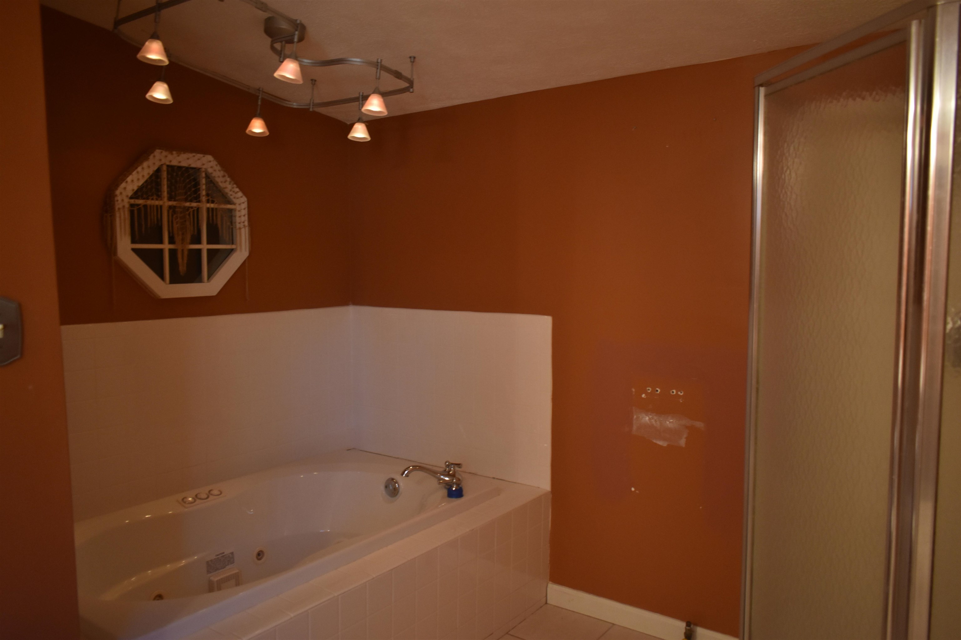 115 Falcon Street Selmer, TN 38375 - Photo 13 of 29 a bathroom with a bathtub and shower