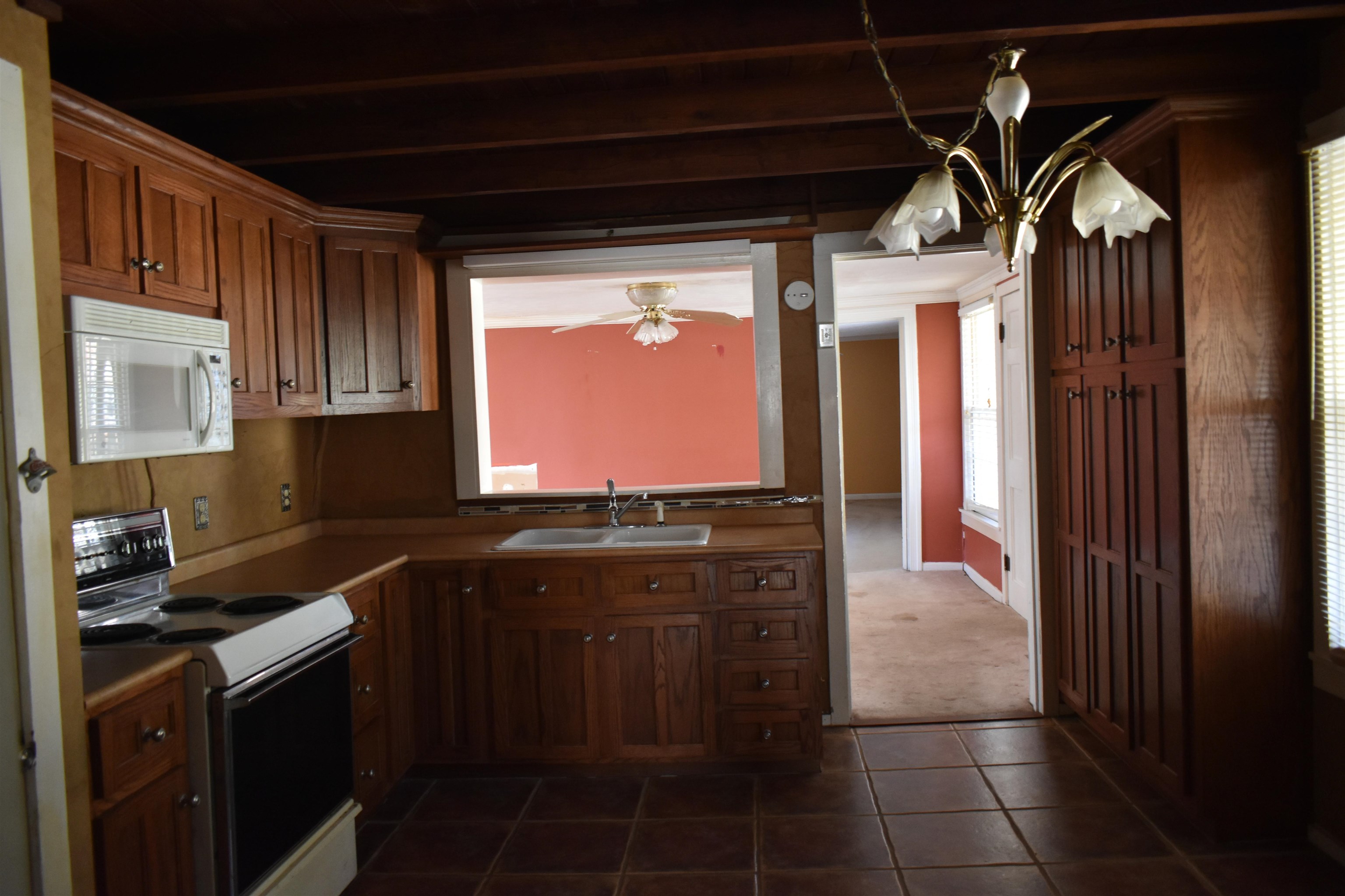 115 Falcon Street Selmer, TN 38375 - Photo 6 of 29 a kitchen with granite countertop a sink stove and cabinets