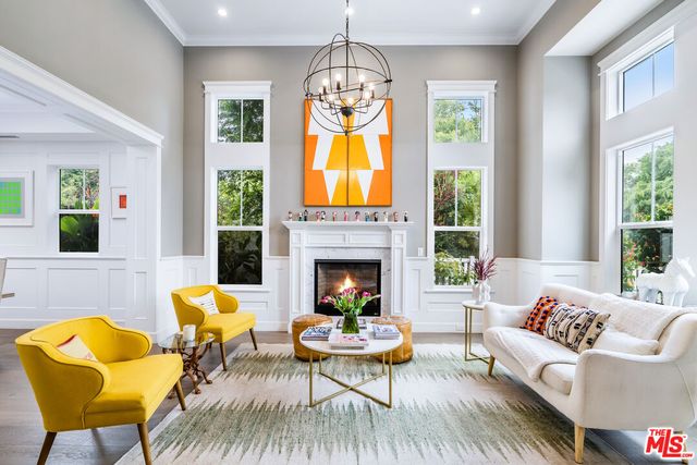 a living room with furniture fireplace and window