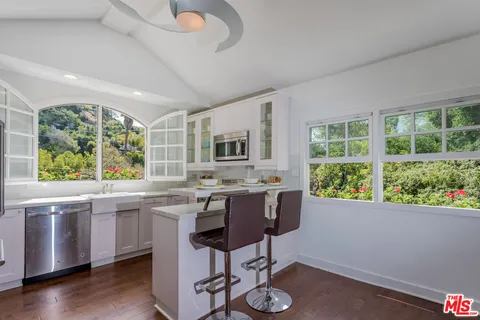 a view of a kitchen area with furniture window and wooden floor