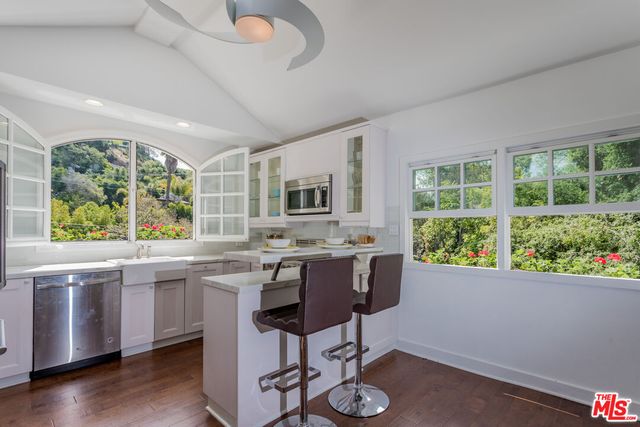 a view of a kitchen area with furniture window and wooden floor