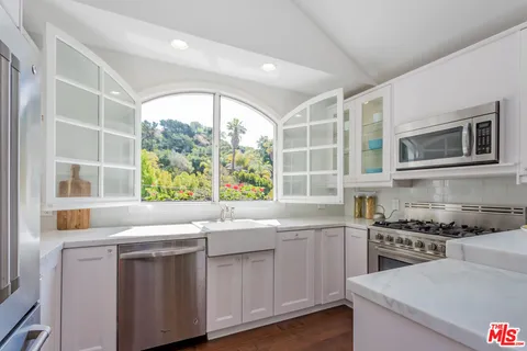 a kitchen with a sink and a stove top oven