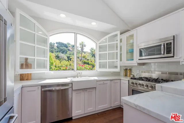 a kitchen with a sink and a stove top oven