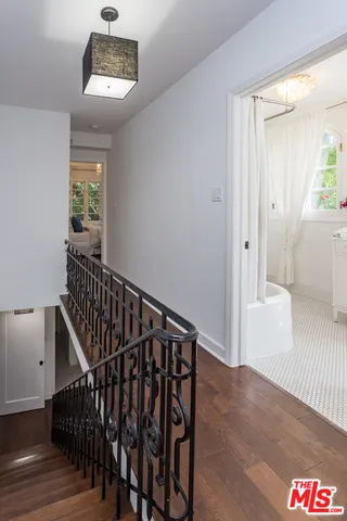 a view of entryway and hall with wooden floor