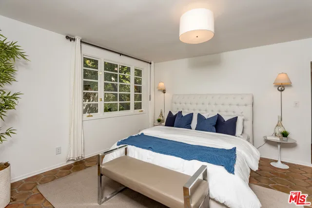 a bedroom with a bed and window