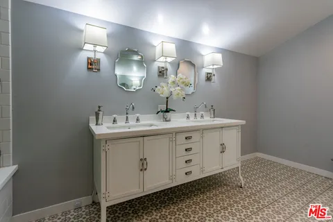 a bathroom with a sink mirror and vanity
