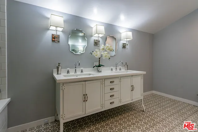 a bathroom with a sink mirror and vanity