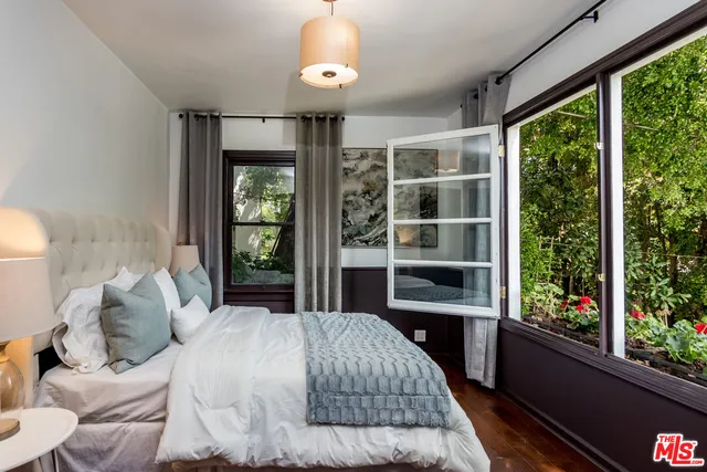 a bedroom with a large bed and a window