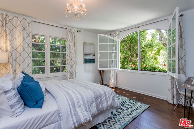 a bedroom with a large bed and a large window
