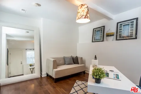 a living room with furniture and a potted plant