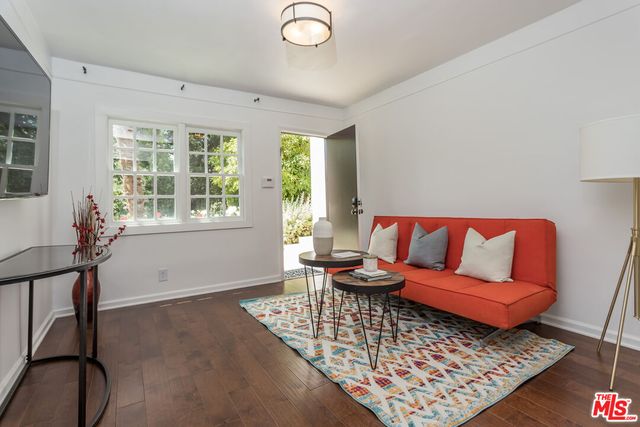 a living room with furniture rug and window