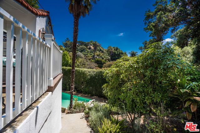 a view of a house with a tree beside it