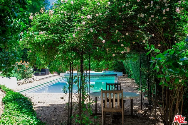 a view of a chairs and table in the backyard
