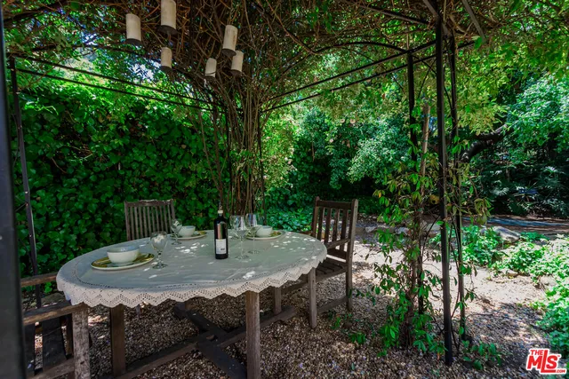 a view of backyard with furniture and plants