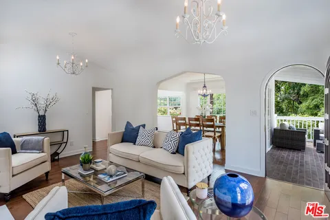 a living room with furniture and a chandelier