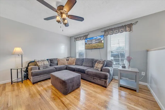a living room with furniture and a wooden floor